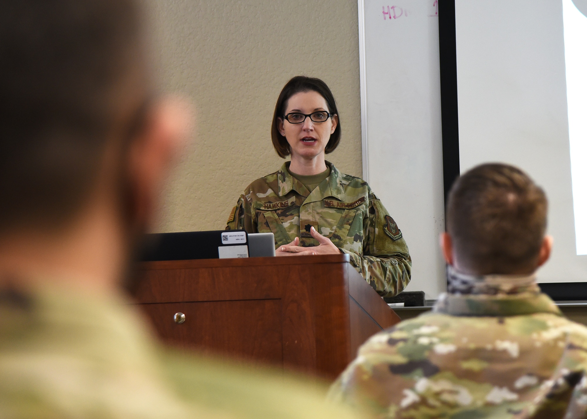 Lt. Col. Hawkins speaks to Airmen in the foreground