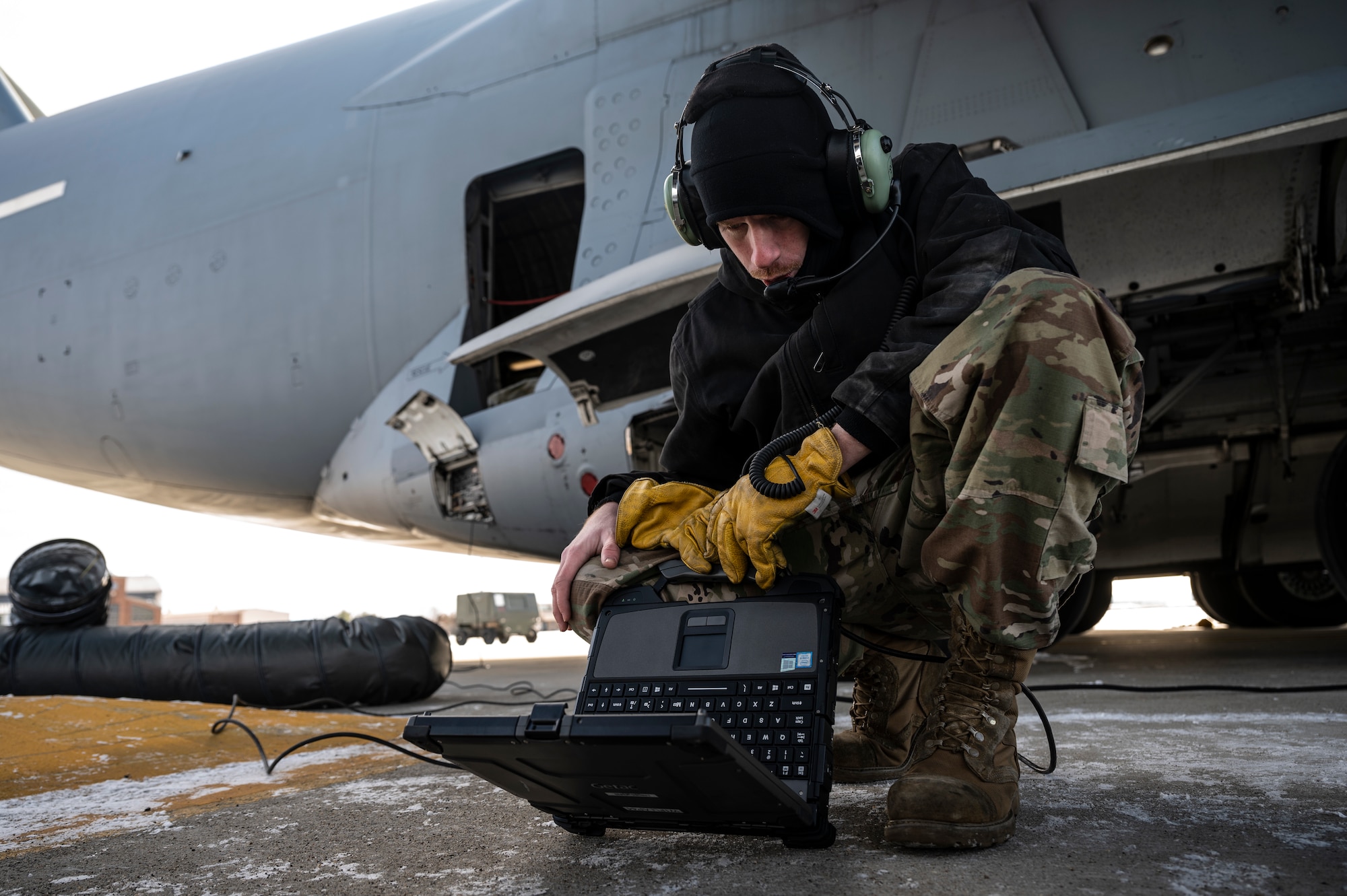 Master Sgt. John Thompson, 911th Aircraft Maintenance Squadron crew chief, reads a technical order while preparing to change a tire on a C-17 Globemaster III at the Pittsburgh International Airport Air Reserve Station, Pennsylvania, Jan. 11, 2022.