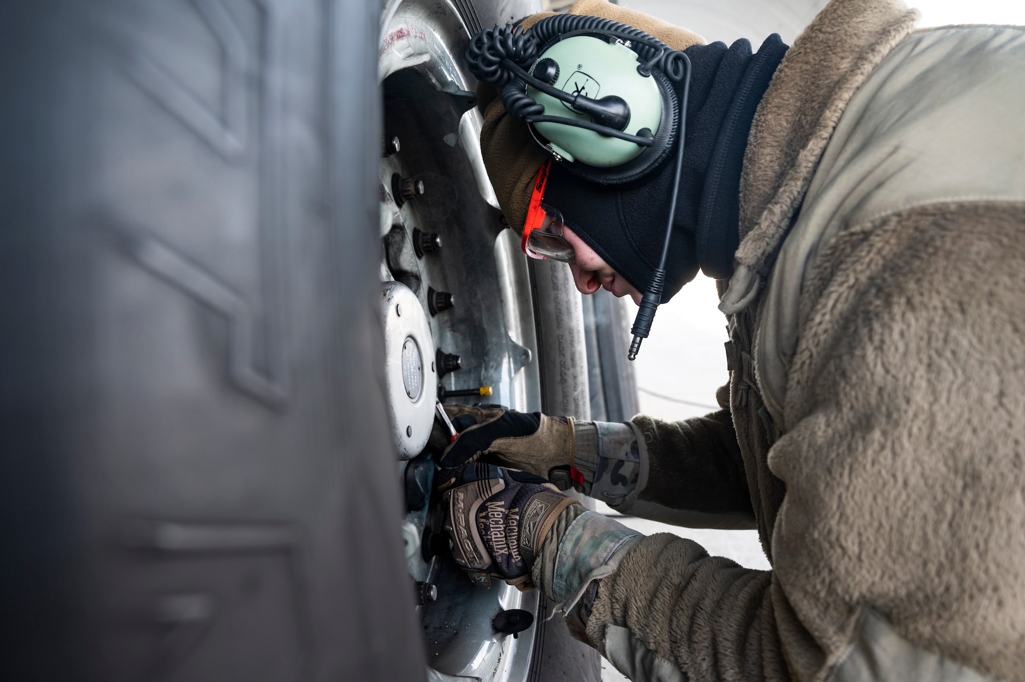 Staff Sgt. Jason Hlavsa, 911th Aircraft Maintenance Squadron crew chief, removes a hubcap while changing a tire on a C-17 Globemaster III at the Pittsburgh International Airport Air Reserve Station, Pennsylvania, Jan. 11, 2022.