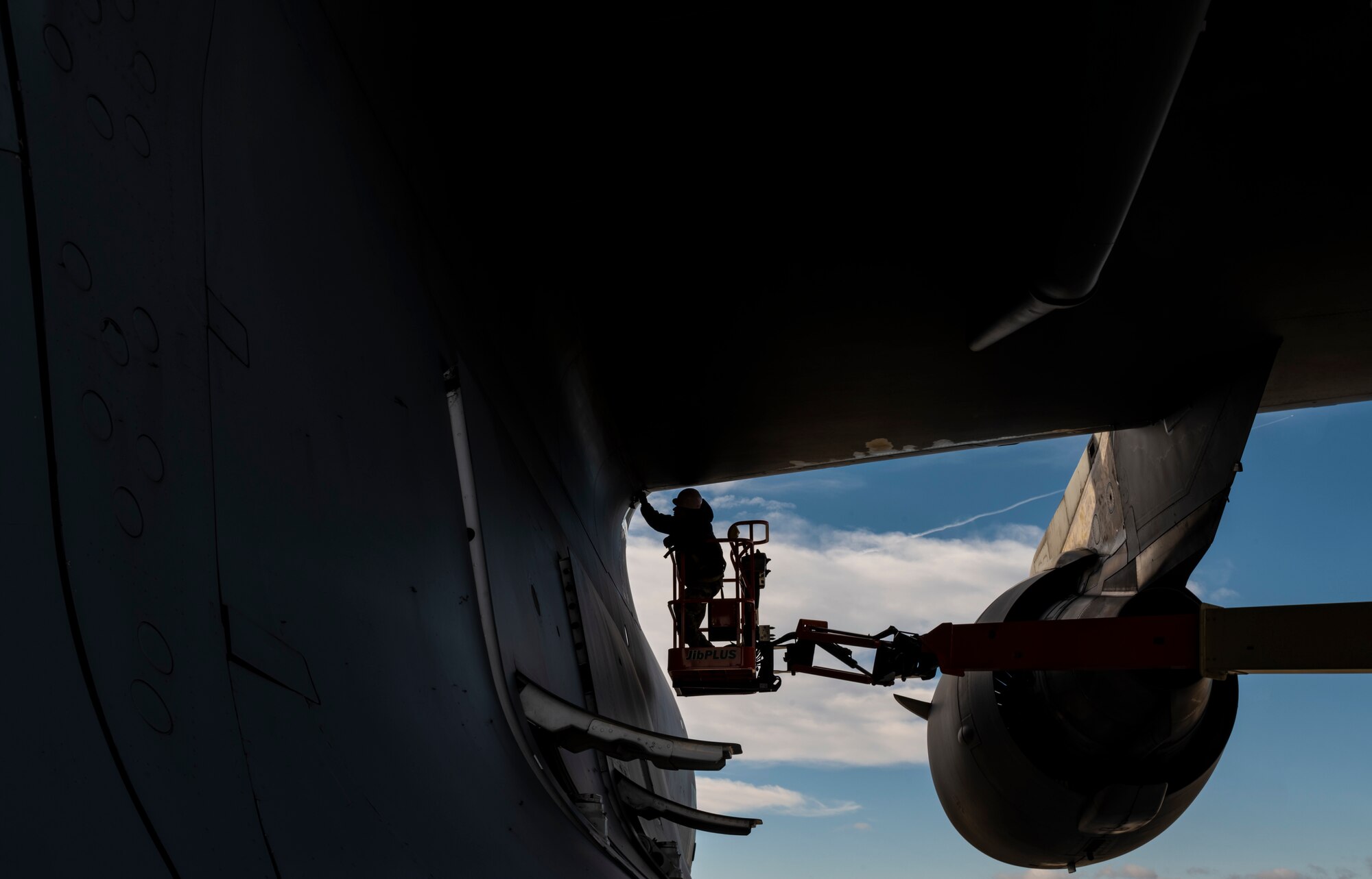 Staff Sgt. Mateo Gomez, 911th Aircraft Maintenance Squadron instrument and flight controls technician, reattaches a panel on a C-17 Globemaster III after inspecting wires at the Pittsburgh International Airport Air Reserve Station, Pennsylvania, Jan. 3, 2022.