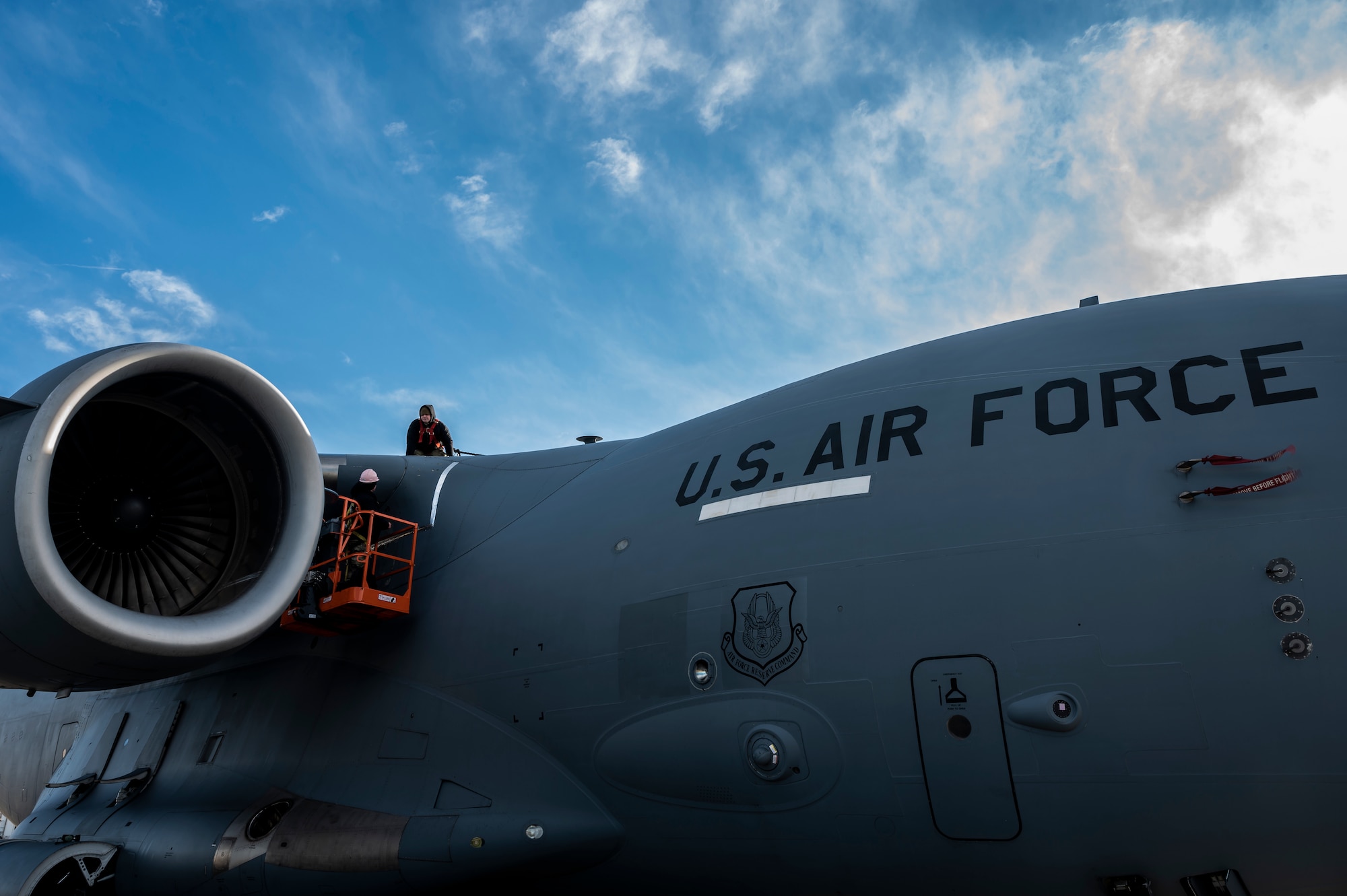 Staff Sgt. Mateo Gomez and Master Sgt. Dustin Dickinson, 911th Aircraft Maintenance Squadron instrument and flight controls technicians, reattach a panel on a C-17 Globemaster III after inspecting wires at the Pittsburgh International Airport Air Reserve Station, Pennsylvania, Jan. 3, 2022.