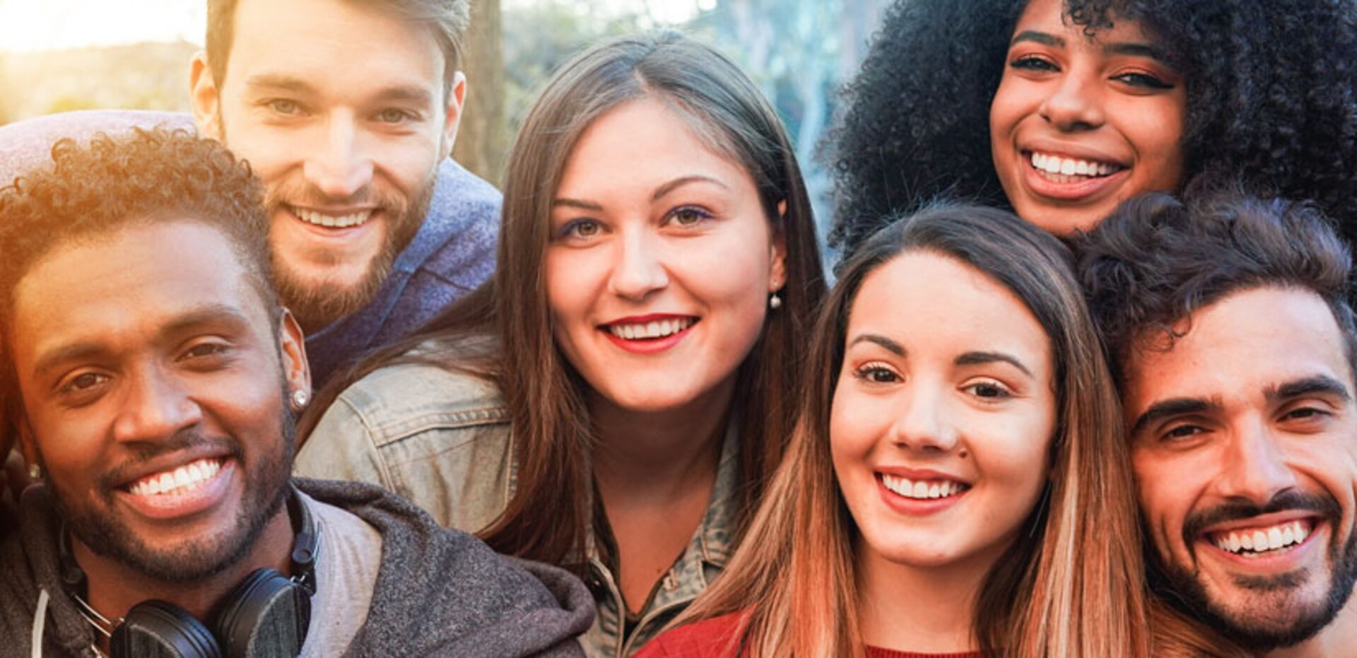 Group of six young adults smiling.