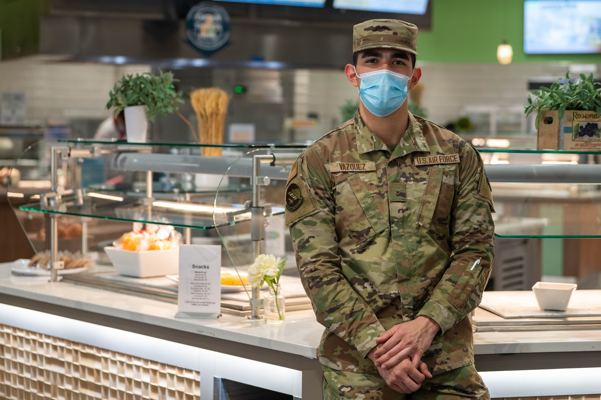 Airman in front of serving counters.