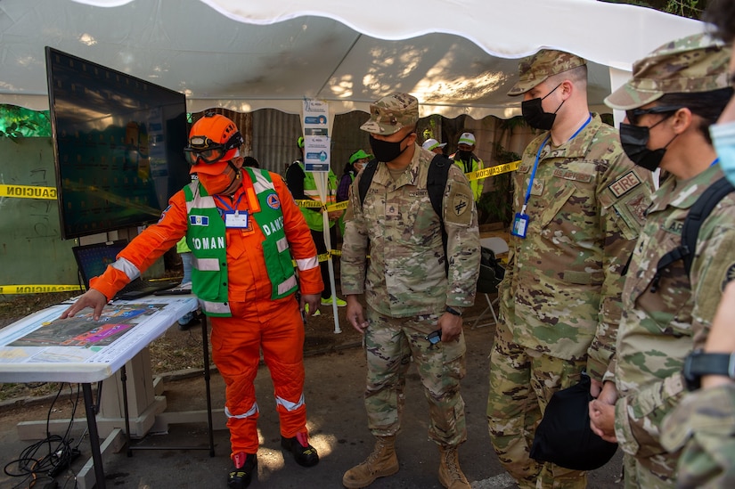 Guatemala City, Guatemala - U.S. Marine Corps Lt. Col. Jacob Reeves, the Joint Task Force-Bravo chief of staff, center, receives an award from Alejandro Eduardo Giammattei Falla, the President of Guatemala, during the closing ceremony of the Coordination Center for Natural Disaster Prevention in Central America and Dominican Republic (CEPREDENAC) II Regional Humanitarian Assistance Drill in Guatemala City, Guatemala, Feb. 4, 2022. JTF-Bravo participated in the CEPREDENAC drill through observation and an aerial firefighting exercise to build partnerships and coordination during natural disasters in the joint operating area.