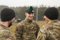 Trooper Shaun Brooke, assigned to the Royal Dragoon Guards, Black Horse Troop, the British army, smiles as he talks with Soldiers assigned to the 2nd Battalion, 34th Armored Regiment, 1st Armored Brigade Combat Team, 1st Infantry Division at Drawsko Pomorskie, Poland, Feb. 08, 2022. British soldiers traveled to Drawsko Pomorskie Training Area to learn more about the U.S. M1A2 Abrams tanks and Bradley Fighting Vehicles. (U.S. Army photo by Spc. Hedil Hernández)