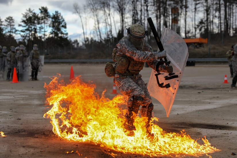 A U.S. Army Soldier assigned to Kentucky National Guard’s 1st Battalion, 149th Infantry Brigade, 116th Infantry Brigade Combat Team, 29th Infantry Division, reacts to a Molotov cocktail during fire phobia training at the Joint Multinational Readiness Center, Hohenfels, Germany, Feb. 11, 2022. Fire phobia training is conducted during mission rehearsal exercises before deployment.