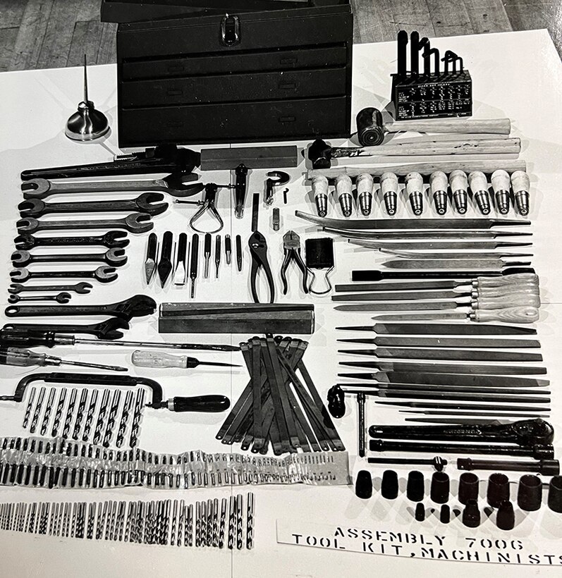 All the components of a machinist's tool kit laid out on a table.