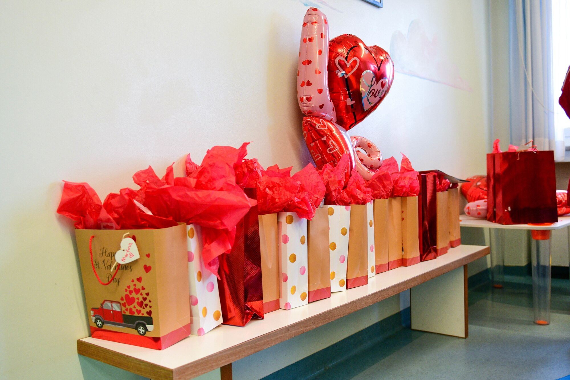 Gift bags for children in the pediatric oncology ward of the Pordenone Hospital are displayed in Pordenone, Italy, Feb. 14, 2022. Four Airmen and civilians from the 31st Security Forces Squadron Pass & Registration office donated 15 gift bags to children on Valentine’s Day to show their appreciation. The gift bags were delivered to children ages 9 months to 15 years old and each gift bag was tailored to the age of the child. (U.S. Air Force photo by Senior Airman Brooke Moeder)