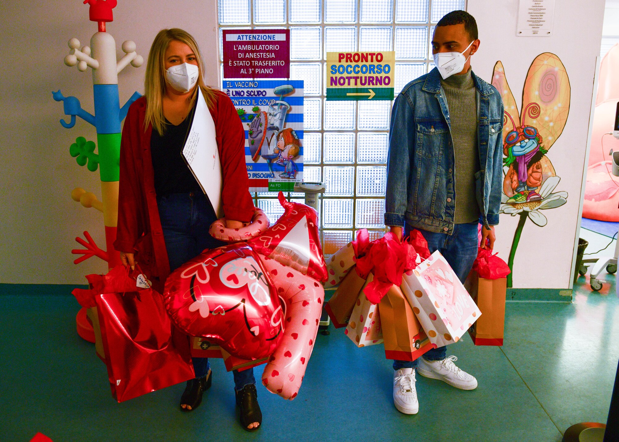 U.S. Air Force Staff Sgt. Hannah Hannas, 31st Security Forces Squadron Pass & Registration assistant noncommissioned officer in charge, and Senior Airman Nelson Roman, 31st SFS Pass & Reg clerk, prepare to bring Valentine’s Day gift bags to children in the pediatric oncology ward of the Pordenone Hospital in Pordenone, Italy, Feb. 14, 2022. Pediatric oncology is the research and treatment of cancers in children and young adults. The gift bags were delivered to children ages 9 months to 15 years old and each gift bag was tailored to the age of the child. (U.S. Air Force photo by Senior Airman Brooke Moeder)