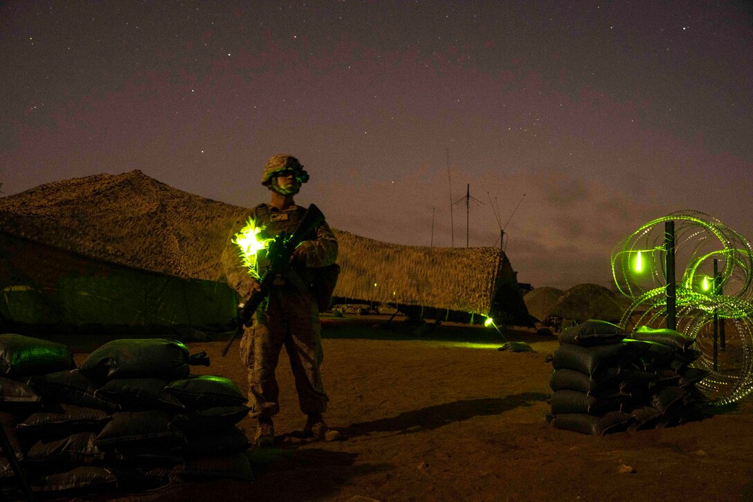 A Marine stands watch at night.