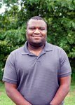 NSWC IHD employee Albert Wright standing in front of trees.