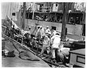 No information available.  Crew coaling an unidentified cutter, no date listed.