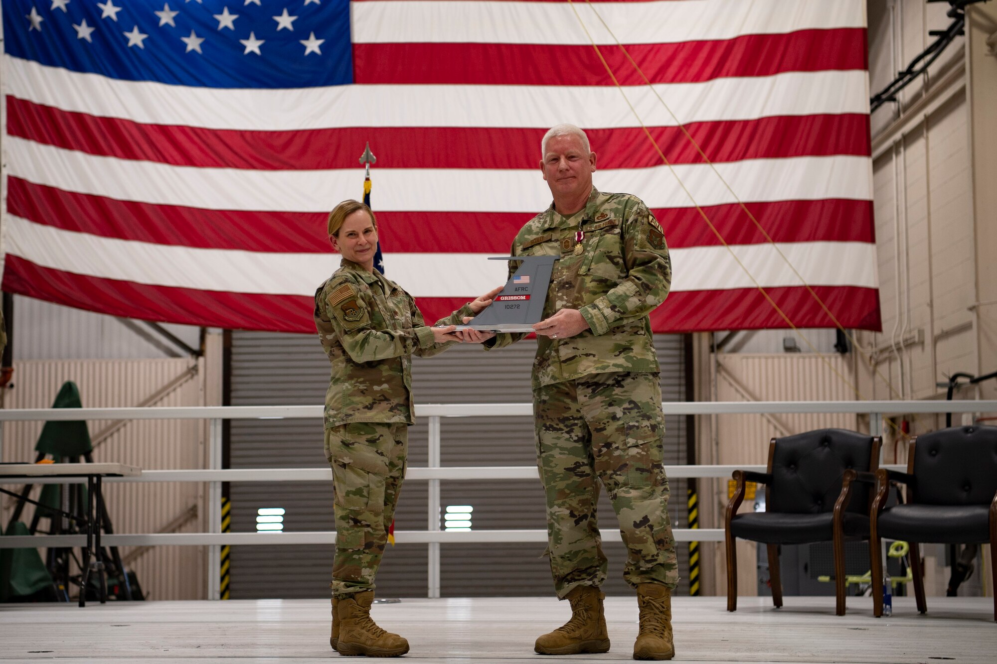 Chief Master Sgt. Richard Scully, 434th Aircraft Maintenance Squadron, maintenance superintendent receives a tail flash from Col. Arianne Mayberry, 434th Maintenance Group, commander at Grissom Air Reserve Base, IN on 6 February, 2022. Chief Scully is retiring after more than 35 years of service, all of which were spent at Grissom. Scully enlisted as open electronics, and became an avionics instrument specialist, now known as guidance and control. In 1994, he spent some time in the military personnel flight, working in customer service, before becoming a quality assurance inspector in AMXS.