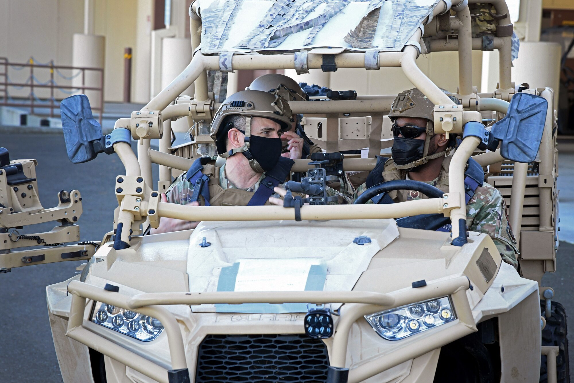 U.S. Air Force Staff Sgt. Arthur Reese, right, 921st Contingency Response Squadron fire team leader, gives Chief Master Sgt. Brian Kruzelnick, Air Mobility Command command chief, a ride in an MRZR light tactical all-terrain vehicle Feb. 11, 2022, at Travis Air Force Base, California. Kruzelnick and Gen. Mike Minihan, AMC commander, got an overview of 621st Contingency Response Wing Airmen deployment capabilities as well as a hands-on experience with some tactical equipment. (U.S. Air Force photo by Master Sgt. Melissa B. White)