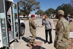 Civilian  and military Air Force leaders greet senior military member arriving for visit.