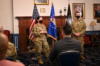 U.S. Air Force Lt. Col. Jane Dunn, 11th Force Support Squadron commander, officiates a ceremony for U.S. Army Sgt. Harly D. Gomme as he transfers into the U.S. Space Force in a ceremony.
