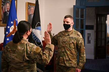 U.S. Air Force Lt. Col. Jane Dunn, 11th Force Support Squadron commander, officiates a ceremony for U.S. Army Sgt. Harly D. Gomme as he transfers into the U.S. Space Force.