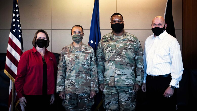 Posing together for a picture before a meeting, (from left to right) Patricia Austin, Exchange Regional vice president, U.S. Air Force Col. Ericka S. Farmerhill, 50th Mission Support Group commander, U.S. Air Force Chief Master Sgt. Kevin Osby, Army & Air Force Exchange Service’s senior enlisted advisor and Chris Holifield, Exchange Colorado Springs Consolidated general manager at Schriever Space Force Base, Colorado, Feb. 8, 2022.