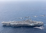 INDIAN OCEAN (June 23, 2021) Aircraft assigned to Carrier Air Wing (CVW) 5 and Indian air force aircraft fly in formation over the U.S. Navy’s only forward-deployed aircraft carrier, USS Ronald Reagan (CVN 76). Ronald Reagan, the flagship of Carrier Strike Group 5, provides a combat-ready force that protects and defends the United States, as well as the collective maritime interests of its allies and partners in the Indo-Pacific region. (Official U.S. Navy file photo)