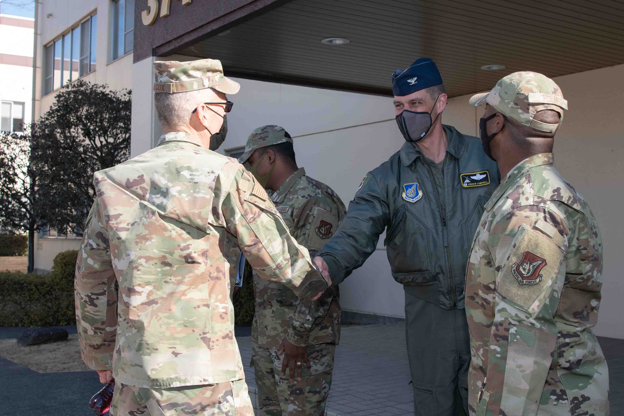 Maj. Gen. Tom Wilcox, left, Air Force Installation and Mission Support Center commander, greets Col. Andrew Campbell, 374th Airlift Wing commander, during a site visit at Yokota Air Base, Japan, Feb. 9, 2022.