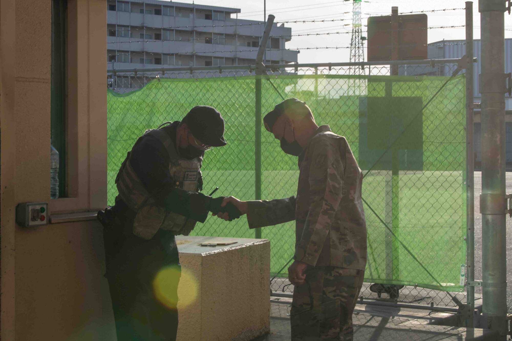 Maj. Gen. Tom Wilcox, Air Force Installation and Mission Support Center commander, greets a defender from the 374th Security Forces Squadron during a site visit at Yokota Air Base, Japan, Feb. 9, 2022.