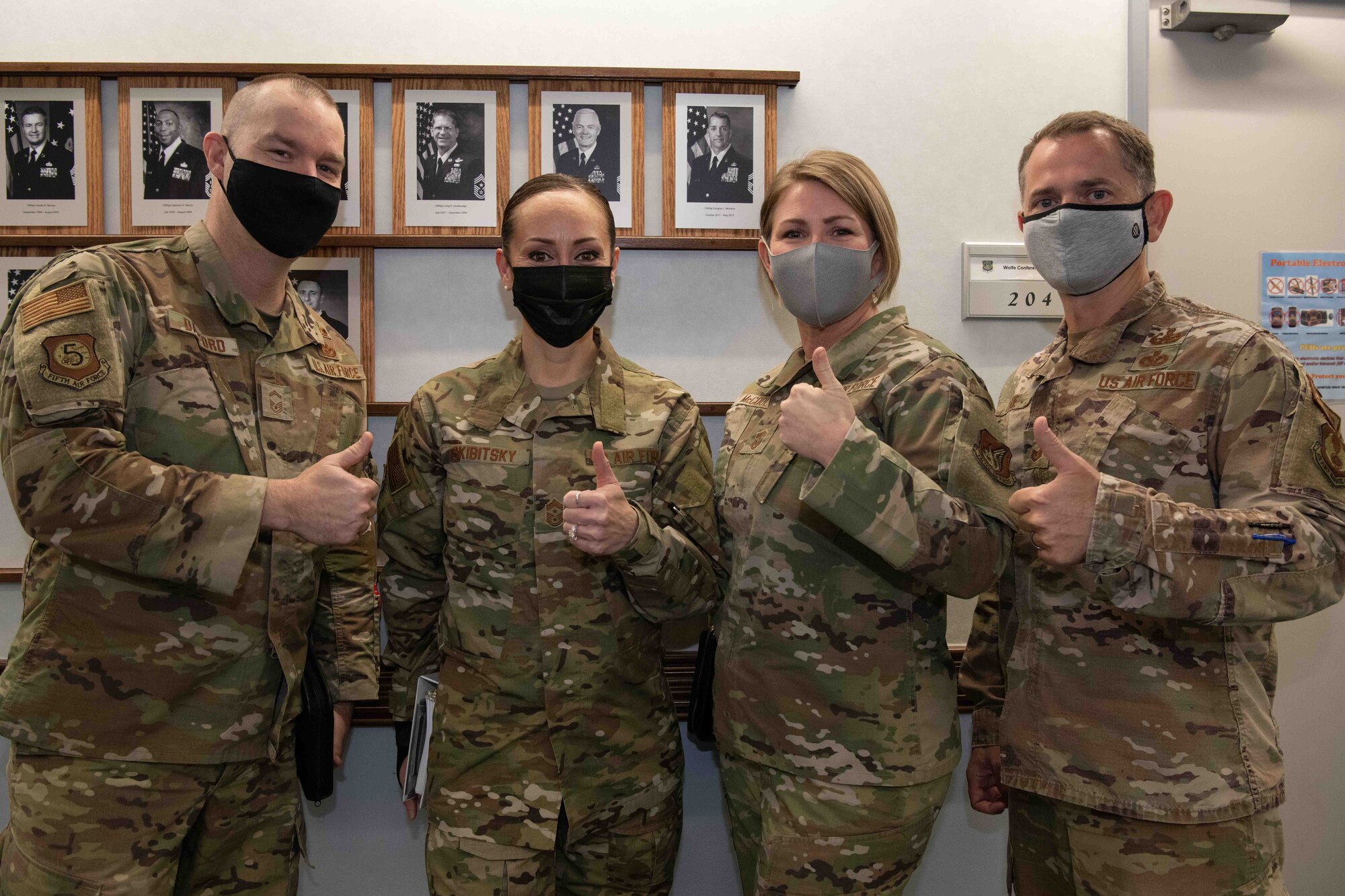 Chief Master Sgt. Hope Skibitsky, center left, Air Force Installation and Mission Support Center command chief, and CMSgt. Katie McCool, center right, Fifth Air Force command chief, meet before a Fifth Air Force briefing during a site tour at Yokota Air Base, Japan, Feb. 9, 2022.