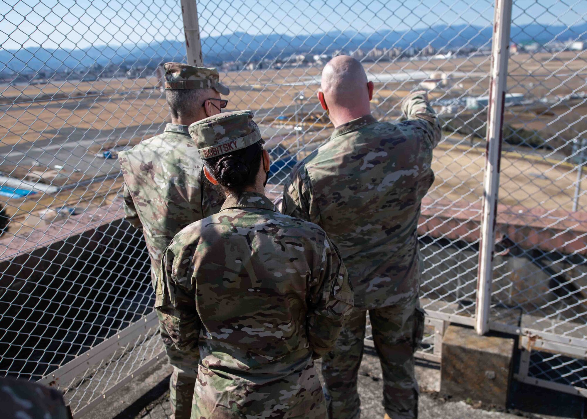 Lt. Col. Timothy Scheffler, right, 374th Civil Engineer Squadron commander, points out project sites to Maj. Gen. Tom Wilcox, Air Force Installation and Mission Support Center commander, and Chief Master Sgt. Hope Skibitsky, AFIMSC command chief, during a site visit at Yokota Air Base, Japan, Feb. 9, 2022.