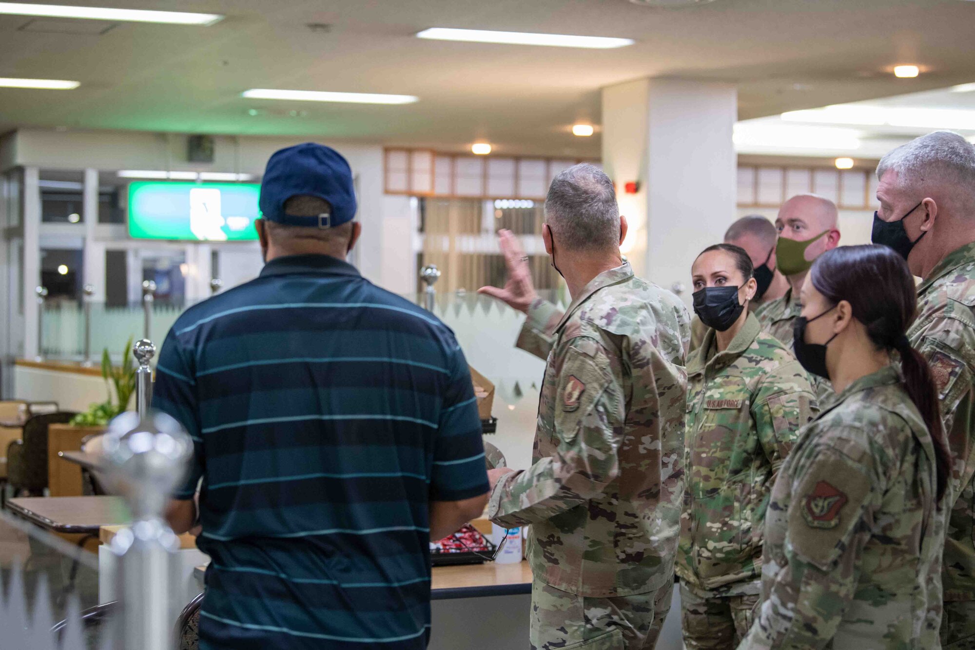 Maj. Gen. Tom Wilcox, Air Force Installation and Mission Support Center commander, center, visits the Samurai Dining Facility during a site visit at Yokota Air Base, Japan, Feb. 9, 2022.