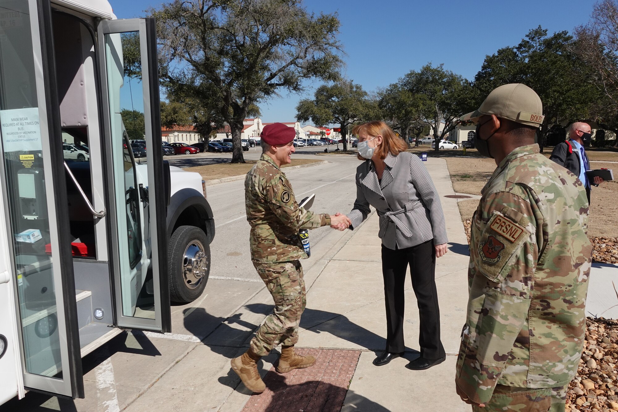 Civilian  and military Air Force leaders greet senior military member arriving for visit.