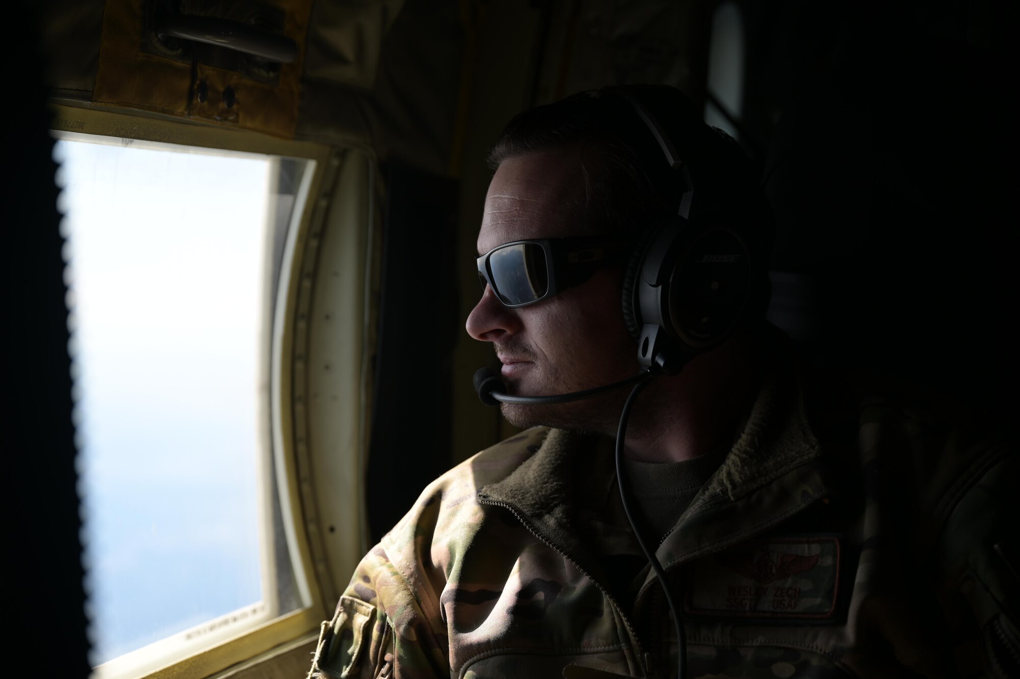Staff. Sgt. Wesley Zech, an instructor loadmaster assigned to the 36th Airlift Squadron, scans the horizon aboard a C-130J Super Hercules near Yokota Air Base, Japan, during exercise Tomodachi Rescue 22 Feb. 11, 2022.
