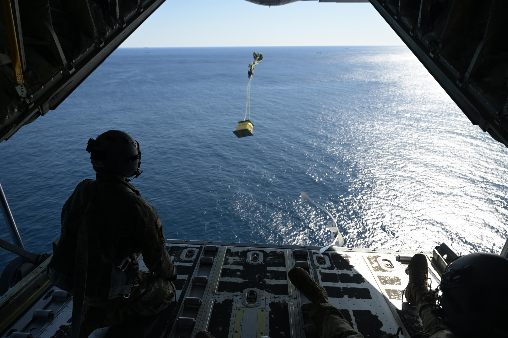 Staff. Sgt. Wesley Zech, left, and Staff Sgt. Mcarthur Posey, loadmasters assigned to the 36th Airlift Squadron, release cargo from a C-130J Super Hercules near the Irozaki Cape, Japan, during exercise Tomodachi Rescue 22 Feb. 11, 2022.