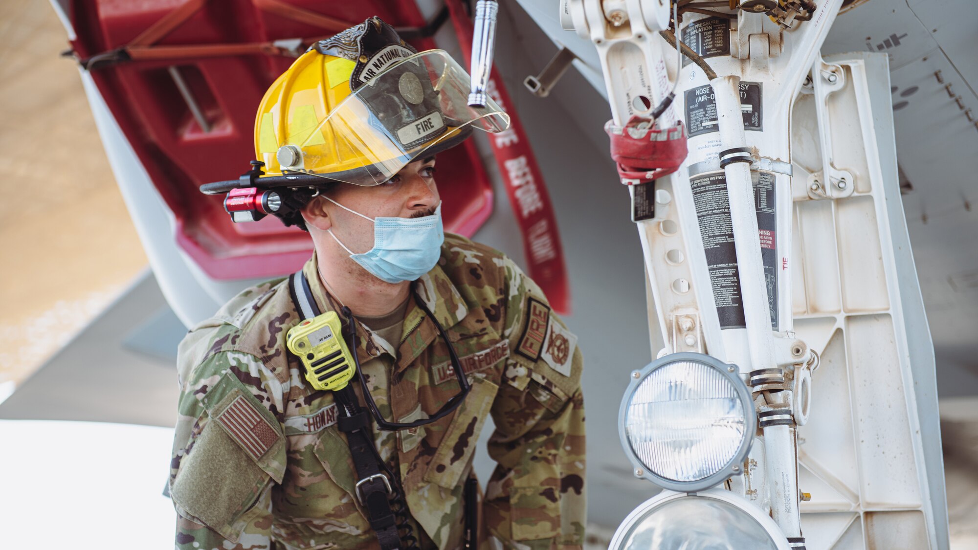 Airman inspects landing gear.