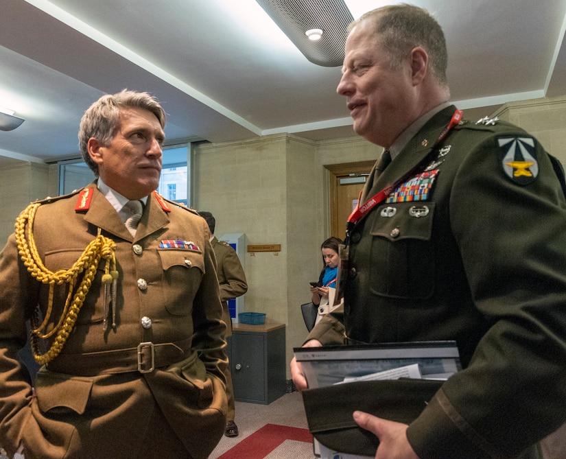 Maj. Gen. Walter (Wally) Rugen, U.S. Army Future Command's Future Vertical Lift Cross-Functional Team director and Major-General James Bowder, Director of Futures, at Army Command, United Kingdom sign a Future Vertical Lift Cooperative Program Feasibility Agreement on behalf of their countries respective services, on Feb. 14, 2022.