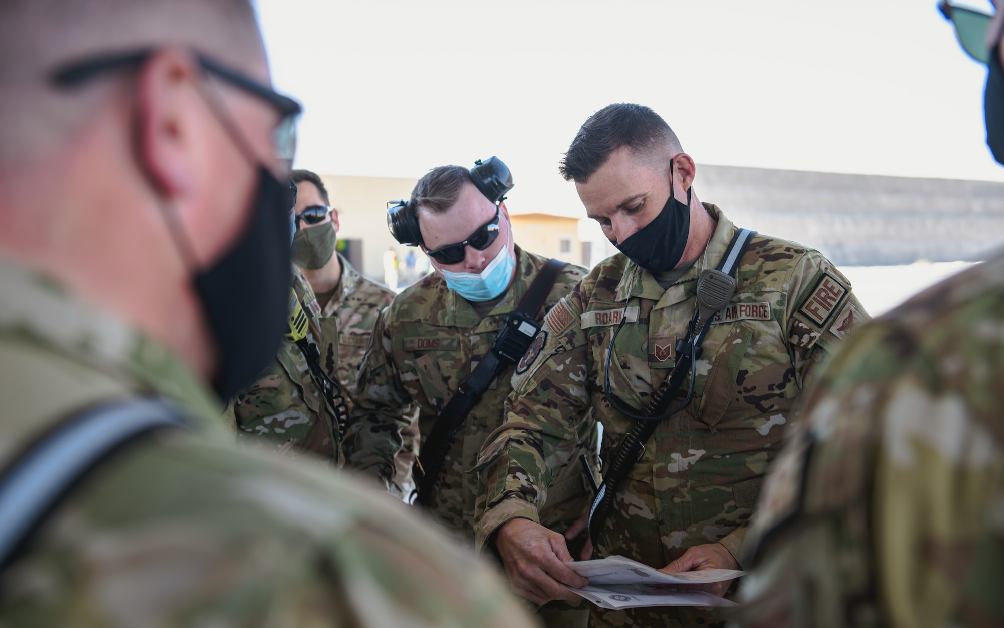 Airmen look at documents.