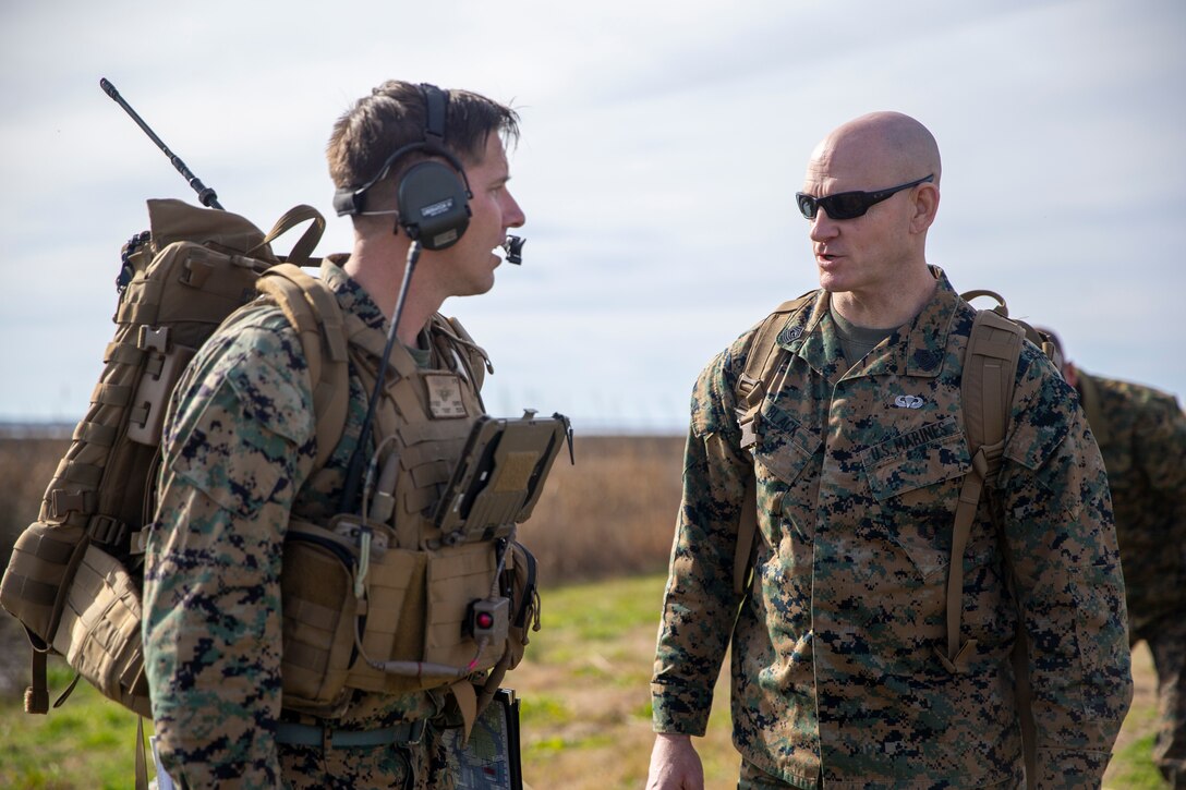 U.S. Marine Corps Sgt. Maj. Troy E. Black, the 19th Sergeant Major of the Marine Corps (right), speaks to Maj. Anthony Fuhrer, an air control officer with 2nd Marine Division, during a close air support demonstration at Marine Corps Air Station Cherry Point, North Carolina, Jan. 13, 2022. The brief was part of a three-day Sergeant Major of the Marine Corps Force Level Summit. The summits are held quarterly to support force level sergeants major at their respective commands. (U.S. Marine Corps photo by Sgt. Victoria Ross)
