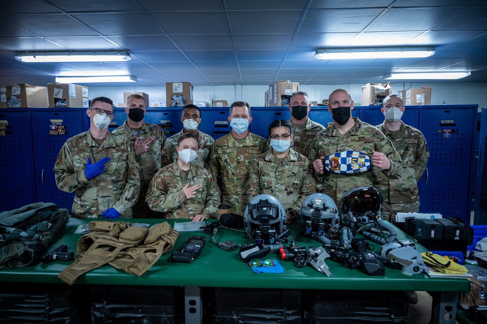 U.S. Air Force Brig. Gen. Christopher Sage, 322d Air Expeditionary Wing commander and Chief Master Sgt. Sean Milligan, command chief, along with Wing Staff members, pose with members of the 55th Expeditionary Fighter Squadron aircrew flight equipment shop in Southwest Asia, Feb. 12, 2022. Chief Milligan's immersion visits give him a better understanding of the unique skillsets every Airman brings to the 332d AEW Red Tail team. (U.S. Air Force photo by Master Sgt. Christopher Parr)