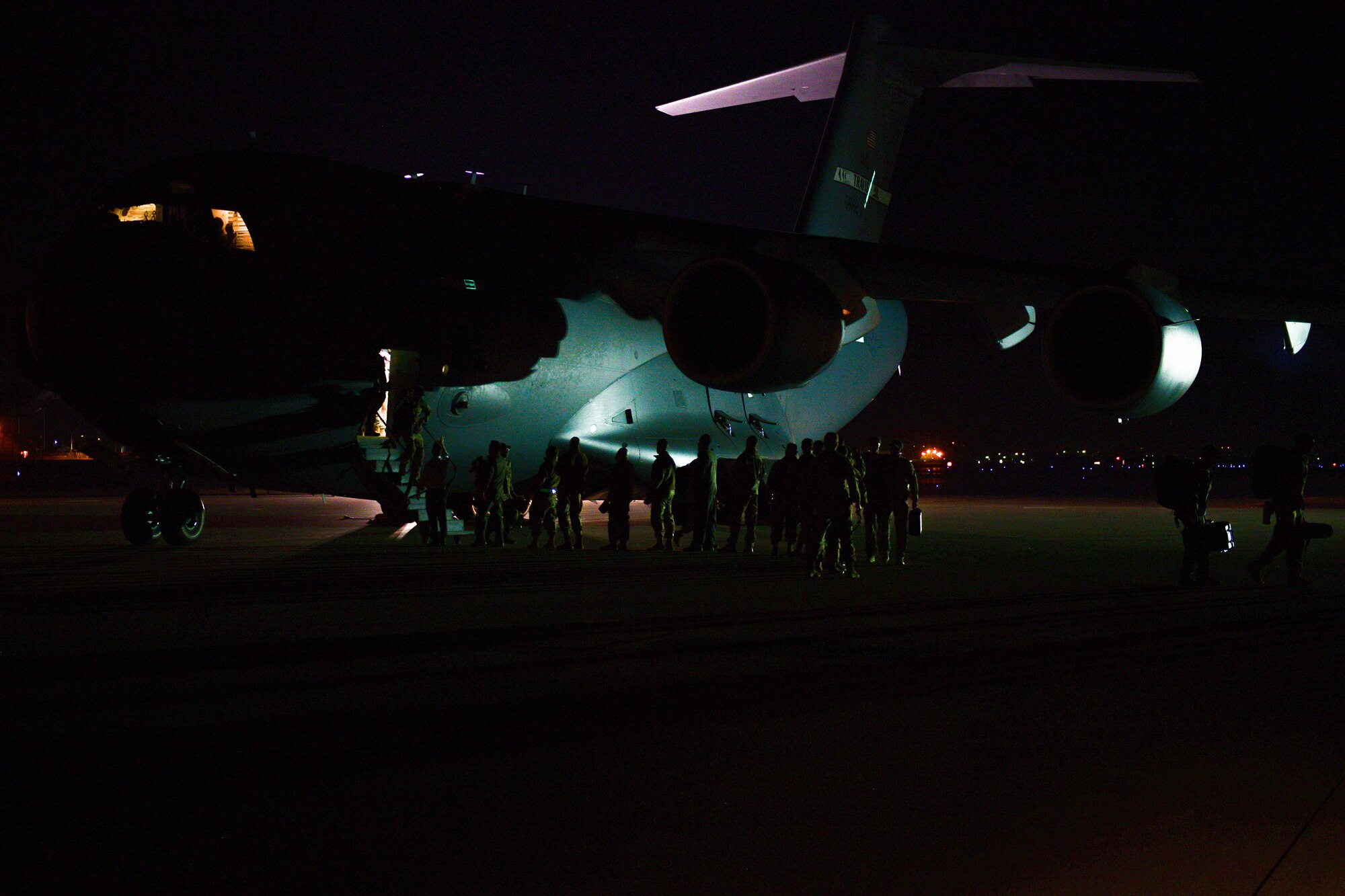 U.S. Air Force Airmen assigned to the 56th Rescue Squadron and 56th Helicopter Maintenance Unit disembark from a C-17 Globemaster after returning from a deployment at Aviano Air Base, Italy, Feb. 9, 2022. The 56th RQS provides a rapidly-deployable, worldwide combat rescue and reaction force response utilizing HH-60G Pave Hawk helicopters. (U.S. Air Force photo by Senior Airman Brooke Moeder)
