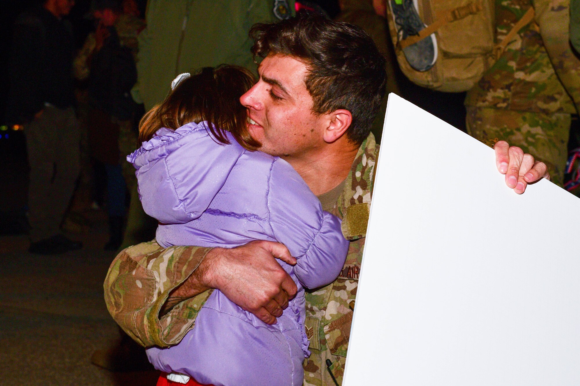 A U.S. Air Force Airman assigned to the 56th Rescue Squadron hugs his family after returning from a deployment, at Aviano Air Base, Italy, Feb. 9, 2022. The 56th RQS offers long-range rescue, humanitarian assistance, non-combatant evacuation and disaster relief capabilities for USEUCOM, USAFRICOM and NATO in peacetime, contingency and wartime operations. (U.S. Air Force photo by Senior Airman Brooke Moeder)
