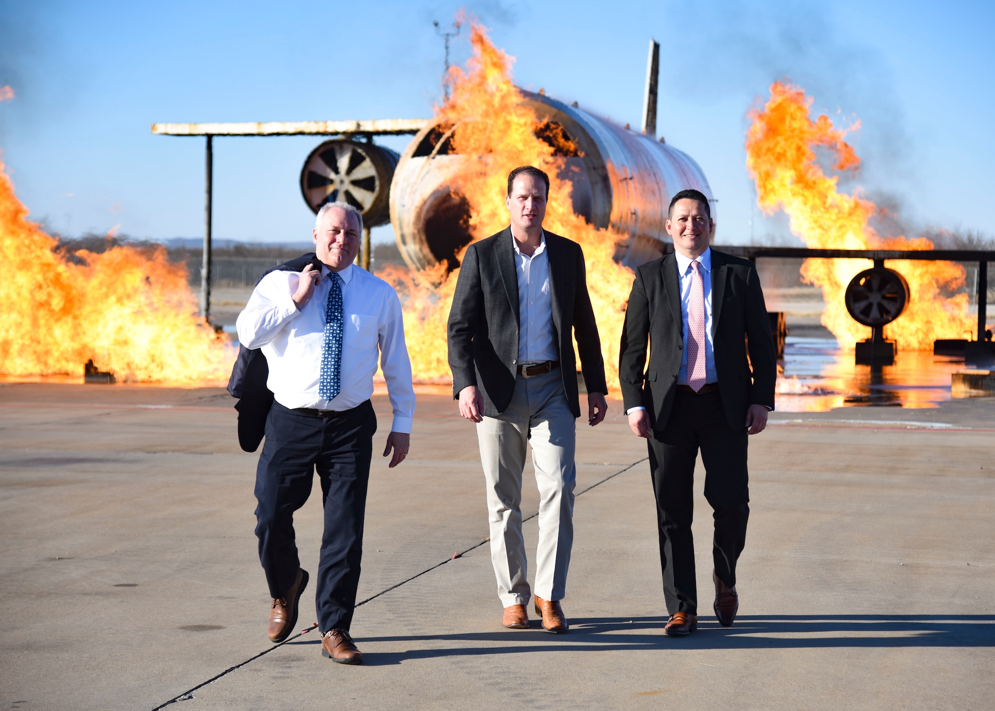 From left, House Minority Whip Steve Scalise and U.S. Representatives August Pfluger and Tony Gonzales walk from a fire training simulator at Goodfellow Air Force Base, Texas.