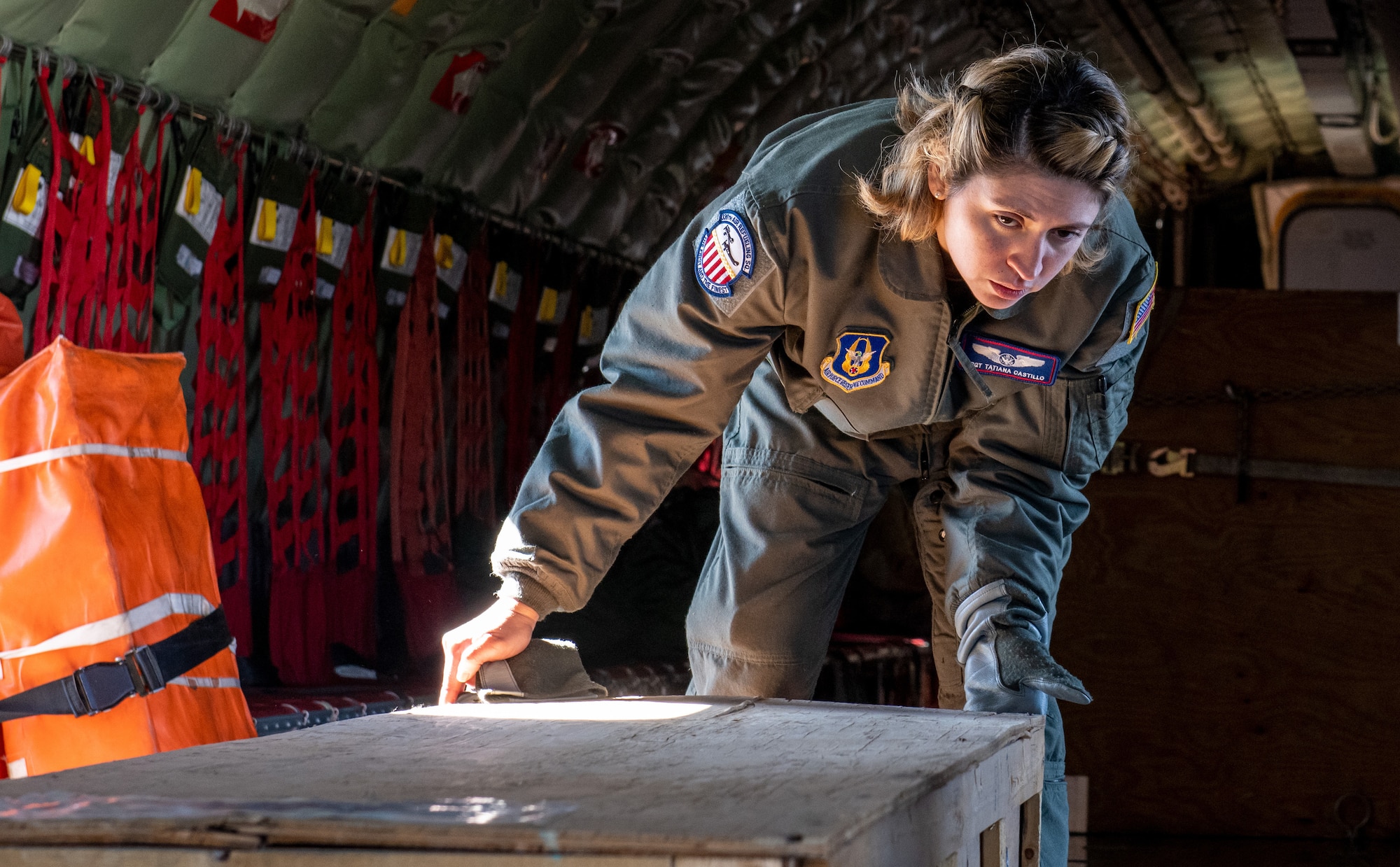 U.S. Air Force Tech. Sgt. Tatiana Castillo, 336th Air Refueling Squadron boom operator from March Air Reserve Base, California, inspects the alignment and securement of an empty casket box during a cargo loading exercise Feb. 5, 2022 at Hill Air Force Base, Utah