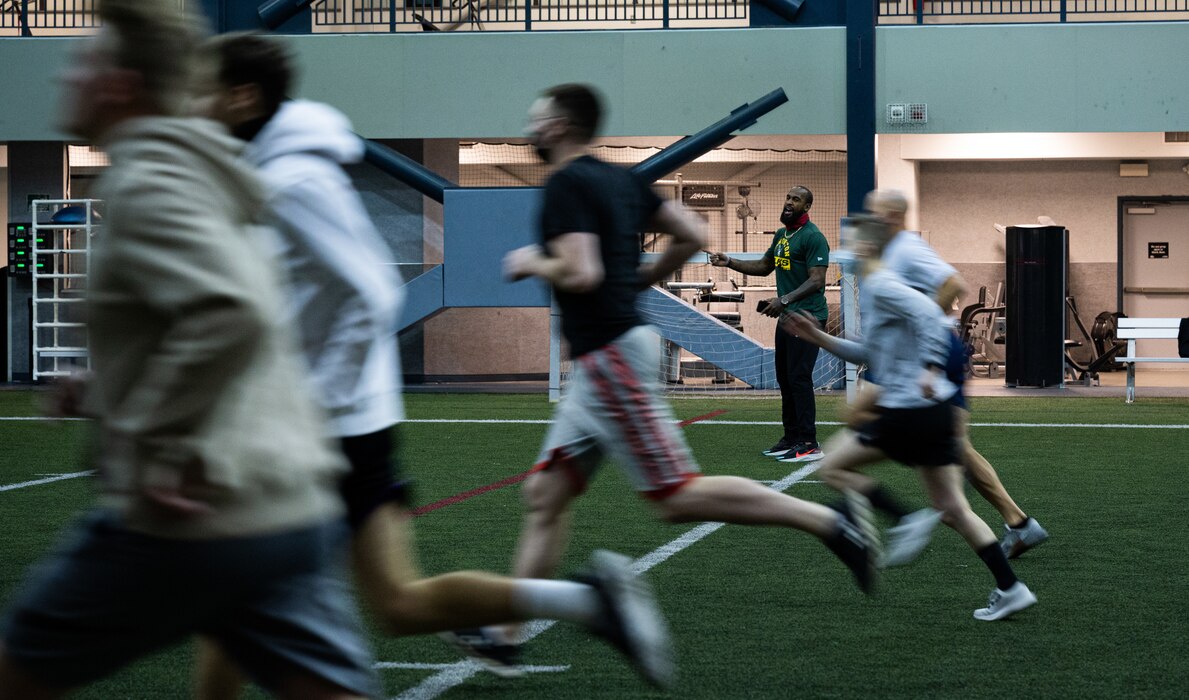 Former National Football League (NFL) player Emmanuel Arceneaux leads Airmen assigned to the 354th Fighter Wing in a workout during Pro Blitz Alaska on Eielson Air Force Base, Alaska, Feb. 11, 2022.