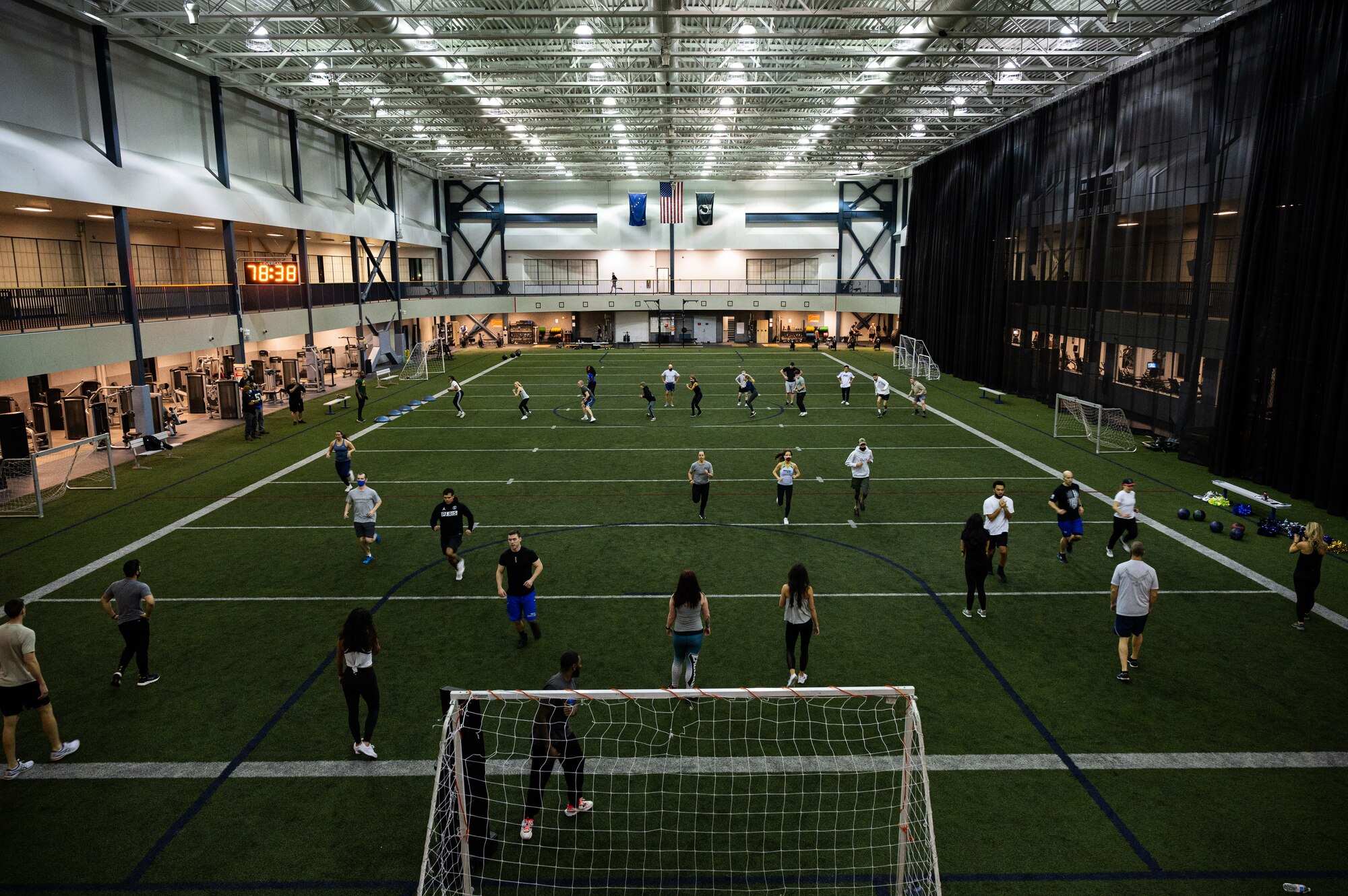 Airmen assigned to the 354th Fighter Wing and National Football League (NFL) cheerleaders  participate in a workout during Pro Blitz Alaska on Eielson Air Force Base, Alaska, Feb. 11, 2022.