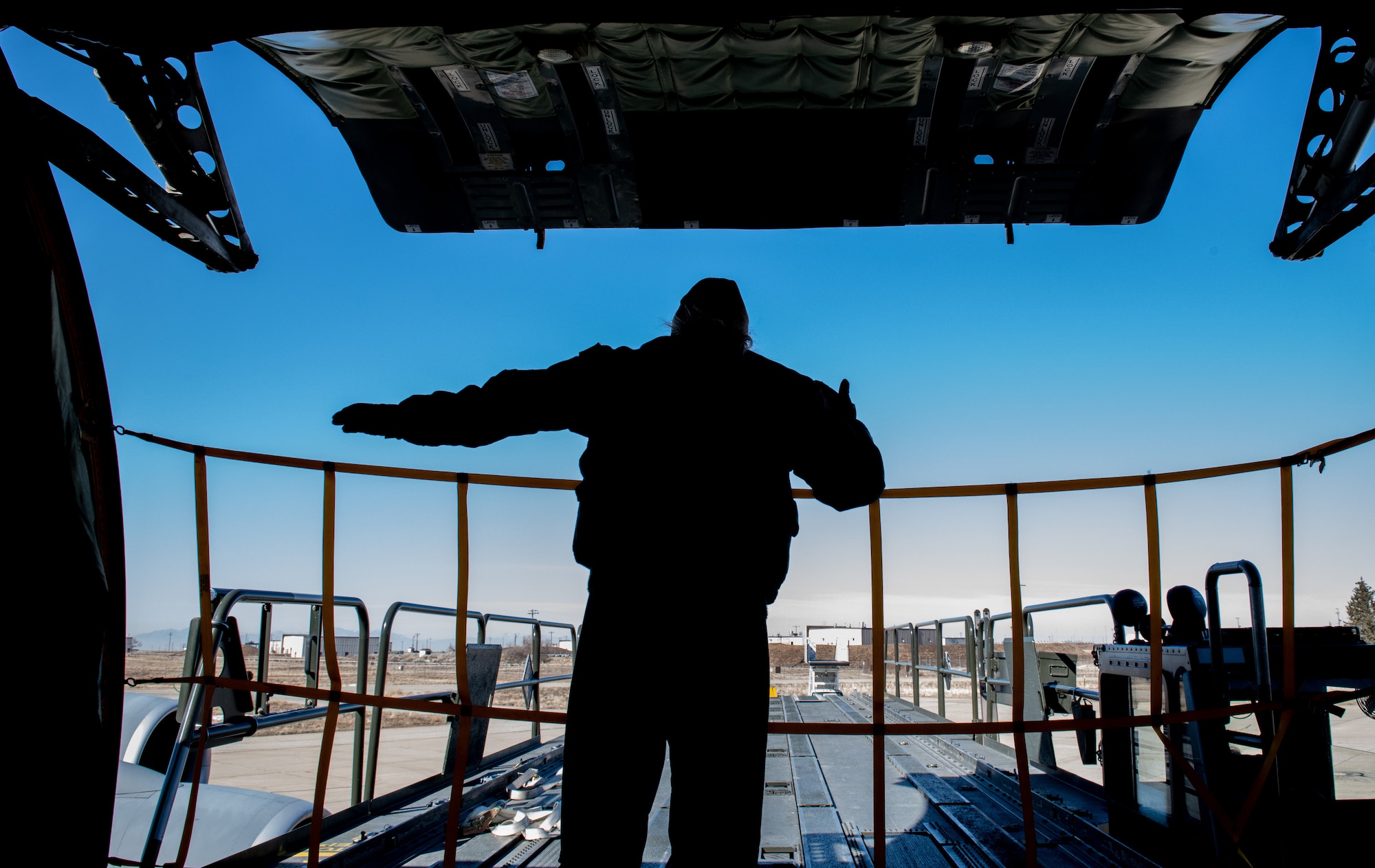 U.S. Air Force Tech. Sgt. Catherine Roberts, boom operator with the 336th Air Refueling Squadron from March Air Reserve Base, California, guides a cargo transport and load vehicle during a loading exercise Feb. 5, 2022 at Hill Air Force Base, Utah