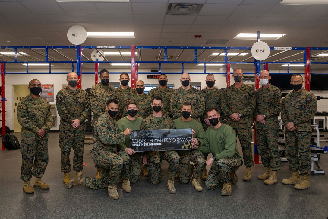 U.S. Marine Corps Sgt. Maj. Troy E. Black, the 19th Sergeant Major of the Marine Corps, poses for a photo with force level sergeants major and Marine instructors, at School of Infantry-East, North Carolina, Jan. 11, 2022. The photo followed a demonstration facilitated by human performance staff and School of Infantry-East students as part of a three-day Force Level Sergeant Major Summit. The summits are held quarterly at different locations to allow various commands to showcase their role in shaping the future of the Marine Corps. (U.S. Marine Corps photo by Sgt. Victoria Ross)