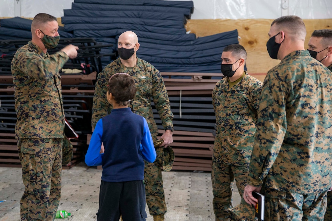 U.S. Marine Corps Sgt. Maj. Troy E. Black, the 19th Sergeant Major of the Marine Corps, speaks with Sgt. Maj. Clifford Fincham, the 2nd Combat Logistics Regiment sergeant major, during a tour of Camp Upshur at Marine Corps Base Quantico, Virginia, Dec. 7, 2021. The purpose of the visit was to tour the facilities at Camp Upshur, meet with service members supporting the Task Force, and discuss future plans for Operation Allies Welcome. The Department of Defense, through U.S. Northern Command, and in support of the Department of Homeland Security, is providing transportation, temporary housing, medical screening, and general support for at least 50,000 Afghan evacuees at suitable facilities, in permanent or temporary structures, as quickly as possible. This initiative provides Afghan personnel essential support at secure locations outside Afghanistan. (U.S. Marine Corps photo by Sgt. Victoria Ross)