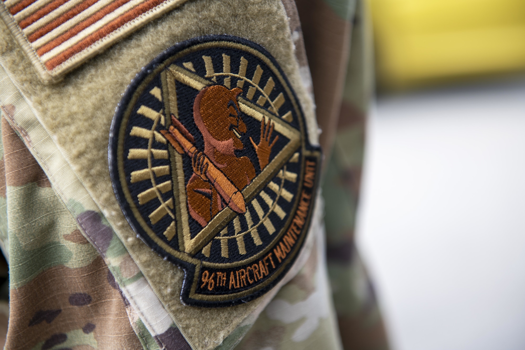 A 96th Bomb Squadron patch is worn by a U.S. Air Force Airman during the arrival of B-52 Stratofortress aircraft at Andersen Air Force Base, Guam. Feb. 11, 2022. Bomber Task Force missions enable crews to maintain a high state of readiness and proficiency, and validate our always-ready global strike capability. (U.S. Air Force photo by Staff Sgt. Lawrence Sena)