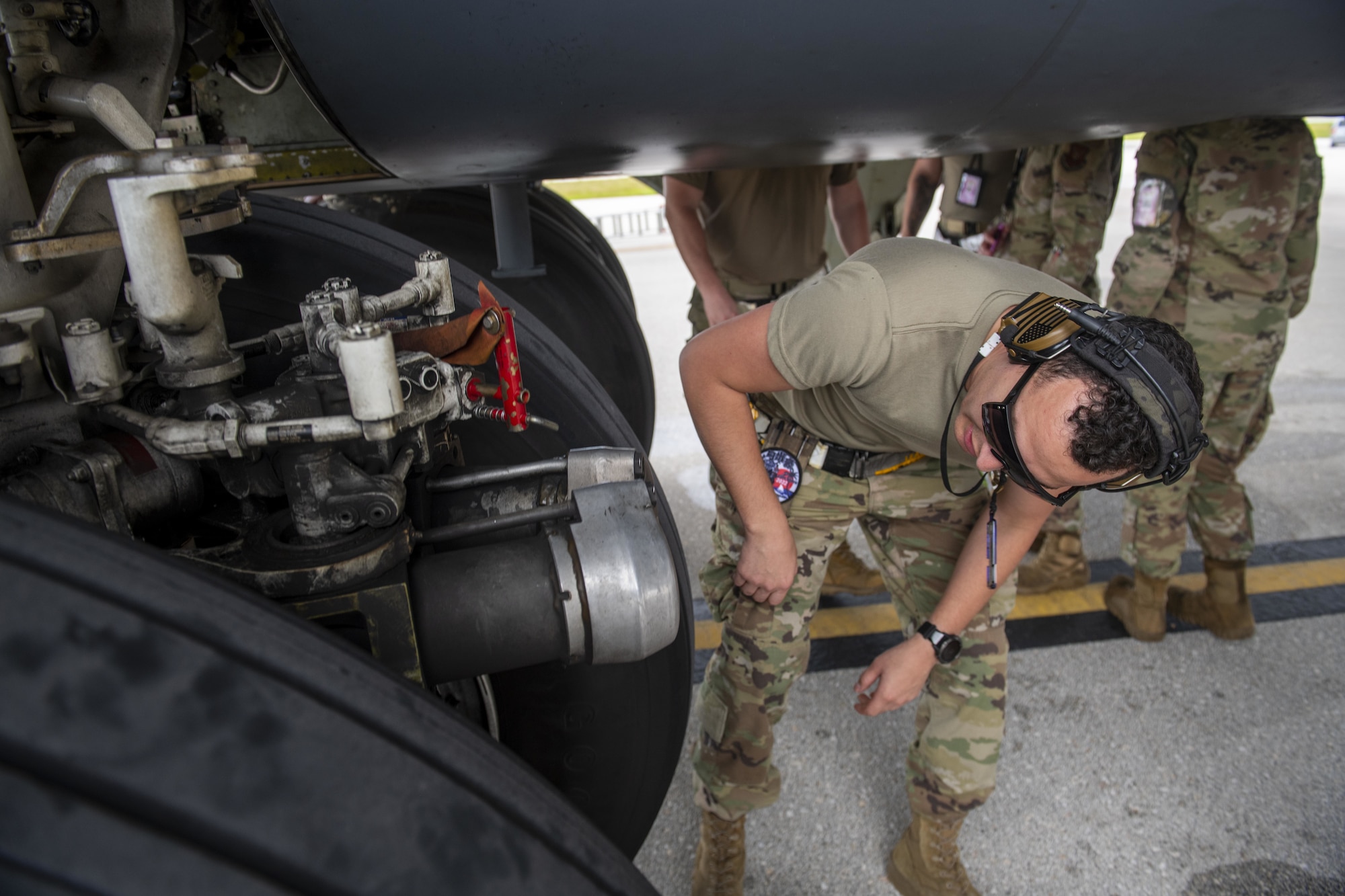 U.S. Air Force Staff Sgt. Noel Lealalegria, 96th Expeditionary Bomb Squadron crew chief, inspects the landing gear of a B-52 Stratofortress during a Bomber Task Force mission at Andersen Air Force Base, Guam, Feb. 11, 2022. Bomber Task Force missions enable crews to maintain a high state of readiness and proficiency, and validate our always-ready global strike capability. (U.S. Air Force photo by Staff Sgt. Lawrence Sena)