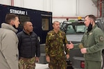 Military leaders from Papua New Guinea speak with Wisconsin National Guard leaders from the 115th Fighter Wing Feb. 5, 2022, in Madison, Wis., during a historic first visit to Wisconsin through the State Partnership Program. The program links individual states with armed forces of partner nations  to forge lasting cooperation, friendship and mutually beneficial relationships.