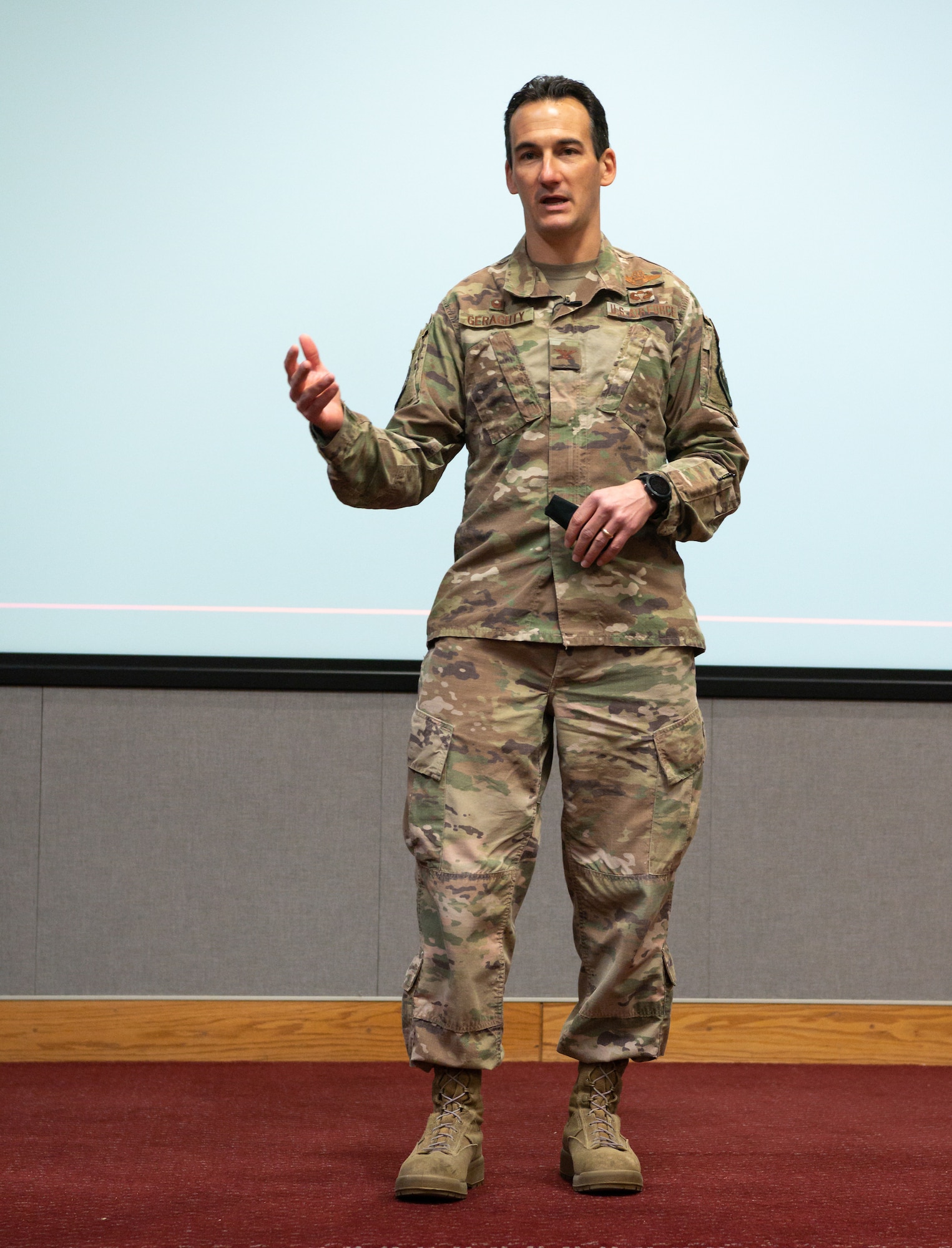 Col. Jeffrey Geraghty standing on stage speaking