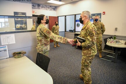 Senior Enlisted Advisor to the Chairman of the Joint Chiefs of Staff (Right) shakes hands with an enlisted accessions recruiter Feb. 9, 2022.